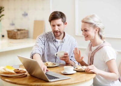 couple surfing web while having breakfast